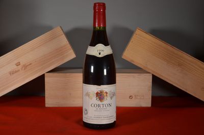 a bottle of wine sitting on a table next to two wooden boxes