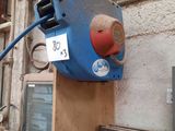 a blue and red device attached to the side of a building