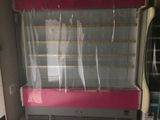 a pink and white display case in a store