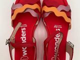 red sandals with colorful straps and buckles on them