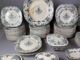 a lot of blue and white plates and bowls on the table