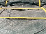 a large pile of black tarps sitting on top of a pallet