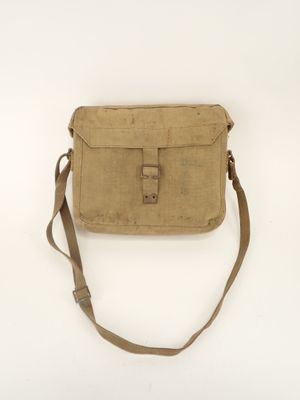 a small tan bag sitting on top of a white surface