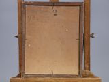 an old wooden easel with a mirror on top of it