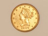 a close up of a gold coin with a woman ' s head on it