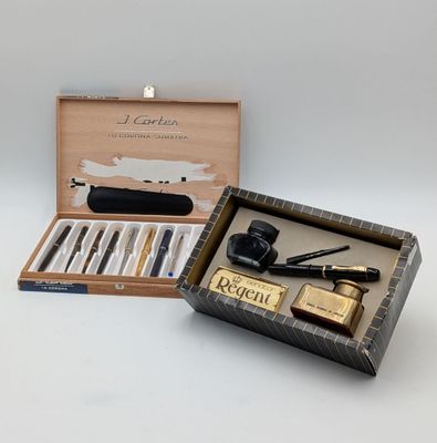 a box with a pen, a pipe, a lighter, and a lighter in it