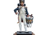 the figurine of a soldier with a drum stands on a wooden base