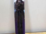 the back of a purple box with a picture of a man in a top hat