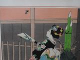 painting of a geisha woman holding a fan in front of a window
