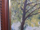 an oil painting of a tree in a wooden frame on a wall