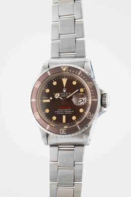 a close up of a wrist watch on a white surface