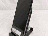a cell phone that is sitting on top of a stand