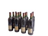 six bottles of wine sitting next to each other on a white surface