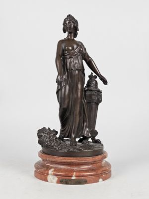 a bronze statue of a woman holding a basket of flowers