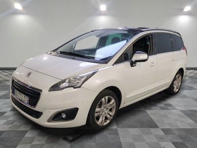 the white minivan is parked in a room with a checkered floor