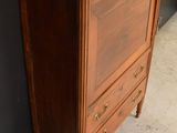 a wooden dresser with a marble top on it