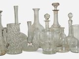 a lot of glass vases that are sitting on a table