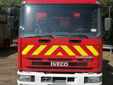 a red fire truck that is parked in the dirt
