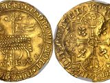 a close up of two gold coins on a white surface
