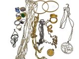 many different types of necklaces and bracelets on a white surface
