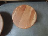 two wooden stools sitting on the floor next to each other
