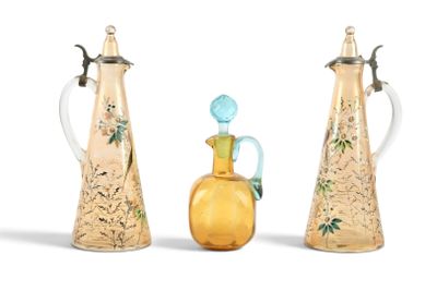 trois vases en verre et une cruche en verre surmontée d'un oiseau