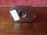 a small metal object on a table with a price tag on it
