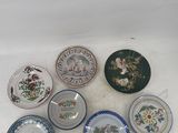 several plates with different designs are arranged on a white surface