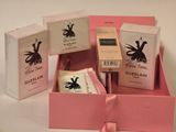 a pink box with three different items inside of it