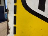 a close up of a yellow and black sign on a table