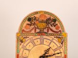a clock that has been decorated with flowers on it