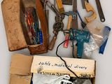 a box full of assorted tools sitting on a table