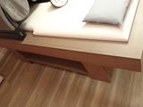 a bed with a pillow and a bag on top of it
