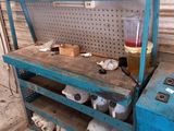 a blue work bench with a bunch of items on top of it