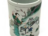 a white cup with a picture of a man and a woman in a garden
