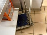tiled floor in a commercial kitchen with a scale on the floor
