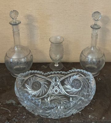 three glass vases and a glass bowl on a table