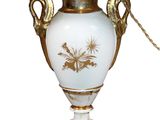 a white vase with a gold decoration on it