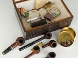 a wooden box with a set of pipes and a lighter
