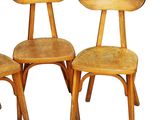 three wooden chairs sitting next to each other on a white surface