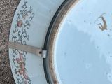 a plate with a knife on it sitting on the ground
