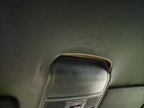 a close up of a car door handle with a cell phone in it