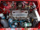 a small engine in the trunk of a red car