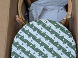 a green and white chair in a cardboard box