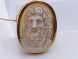 an image of a picture of a man ' s face in a gold ring