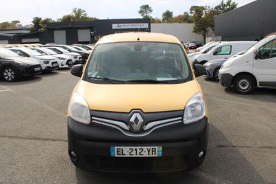 a yellow van parked in a parking lot with other cars