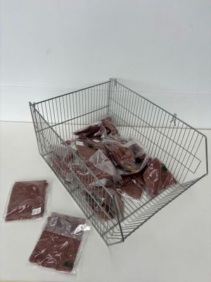 a metal basket filled with meat sitting on top of a table