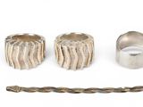 three silver rings and a rope are sitting next to each other