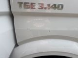 a close up of a white toilet with the lid down