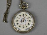 a gold pocket watch with roman numerals on it